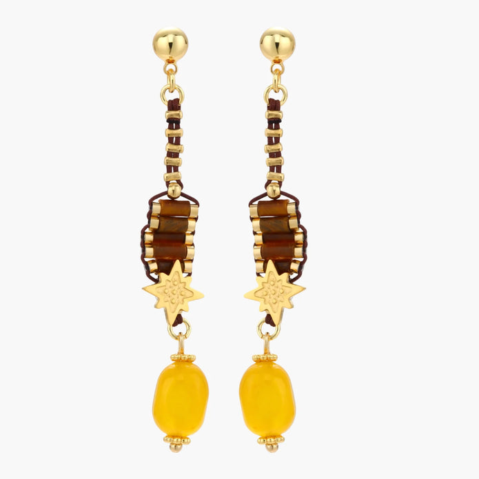 Gold-plated dangle earrings with brown gemstones, star charms, and yellow amber drops on cream background.
