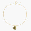 Gold-plated pendant necklace with green enamel background and oval olive cubic zirconia center stone with crystal accents.