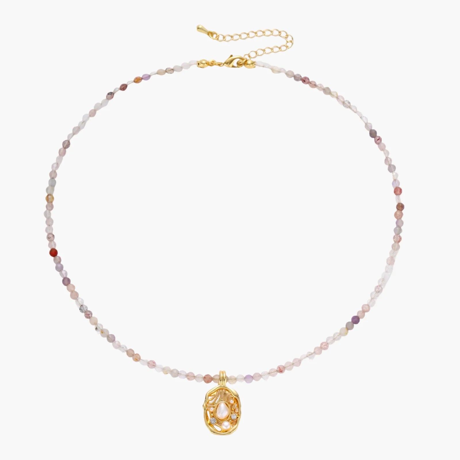 Delicate gold-plated necklace with mixed gemstone beads and ornate oval pendant on white background