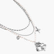 Multi-strand layered necklace set with silver chains, white pearls, star charm, heart pendant, and ornate decorative piece