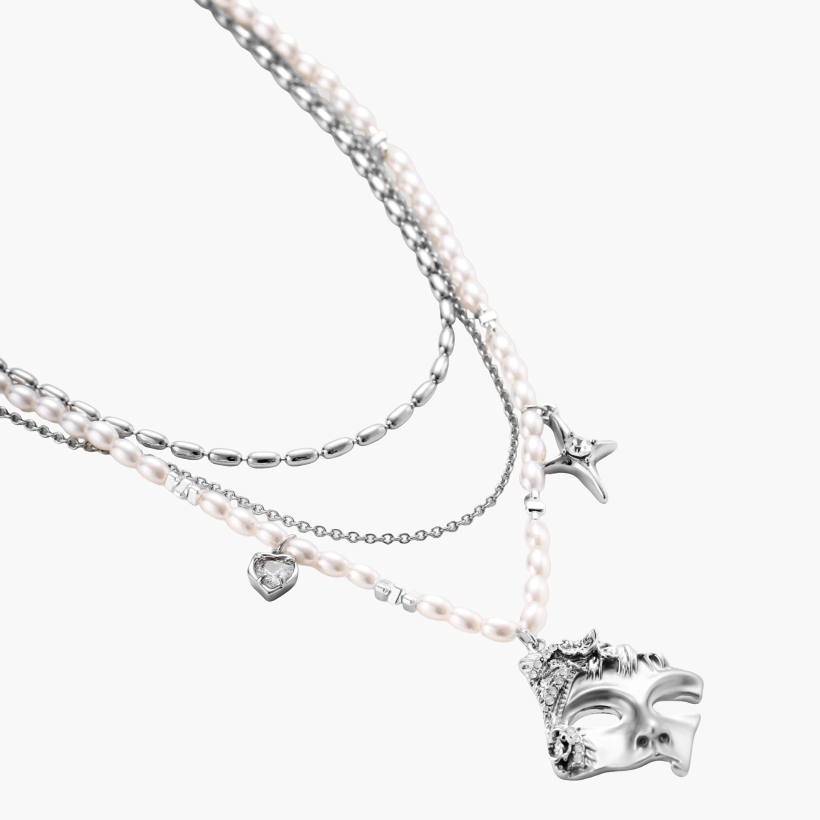 Multi-strand layered necklace set with silver chains, white pearls, star charm, heart pendant, and ornate decorative piece