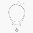 Multi-strand layered necklace set with silver chains, white pearls, star charm, heart pendant, and ornate decorative piece