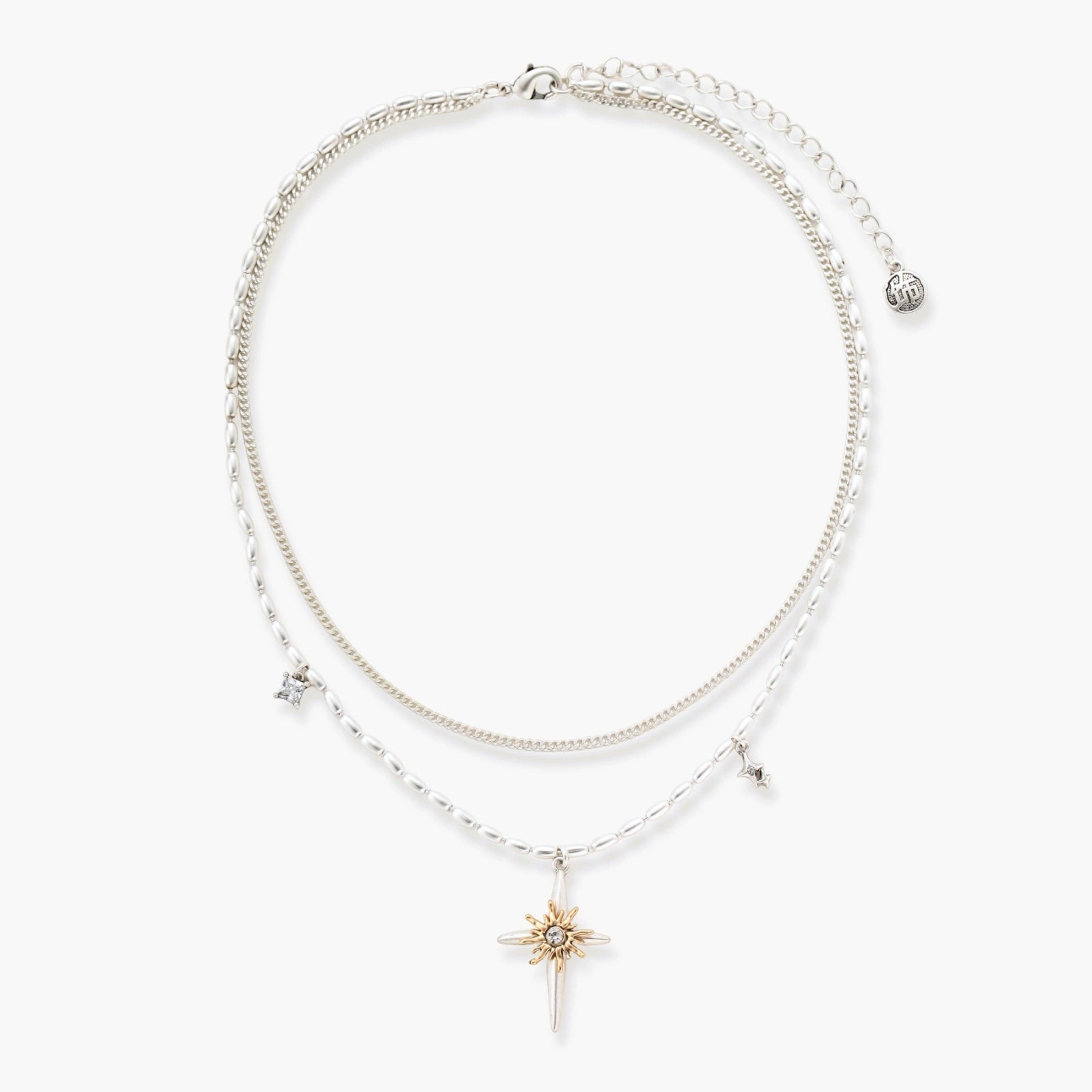 Two-layer silver-toned necklace with star charms and dagger pendant featuring golden sun motif on white background.