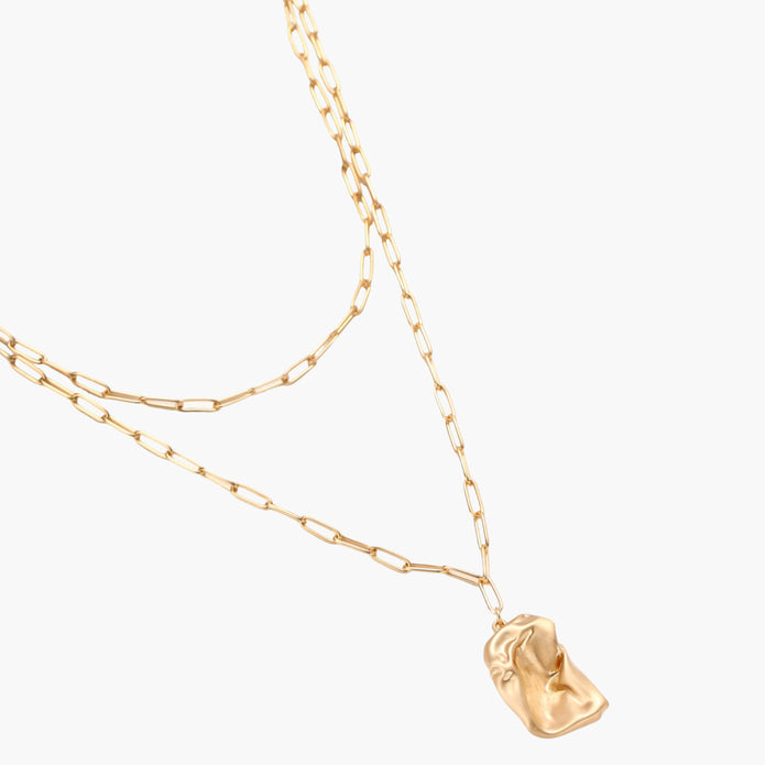Layered paperclip chain necklace with organic flowing pendant made from eco-zinc alloy in warm gold finish