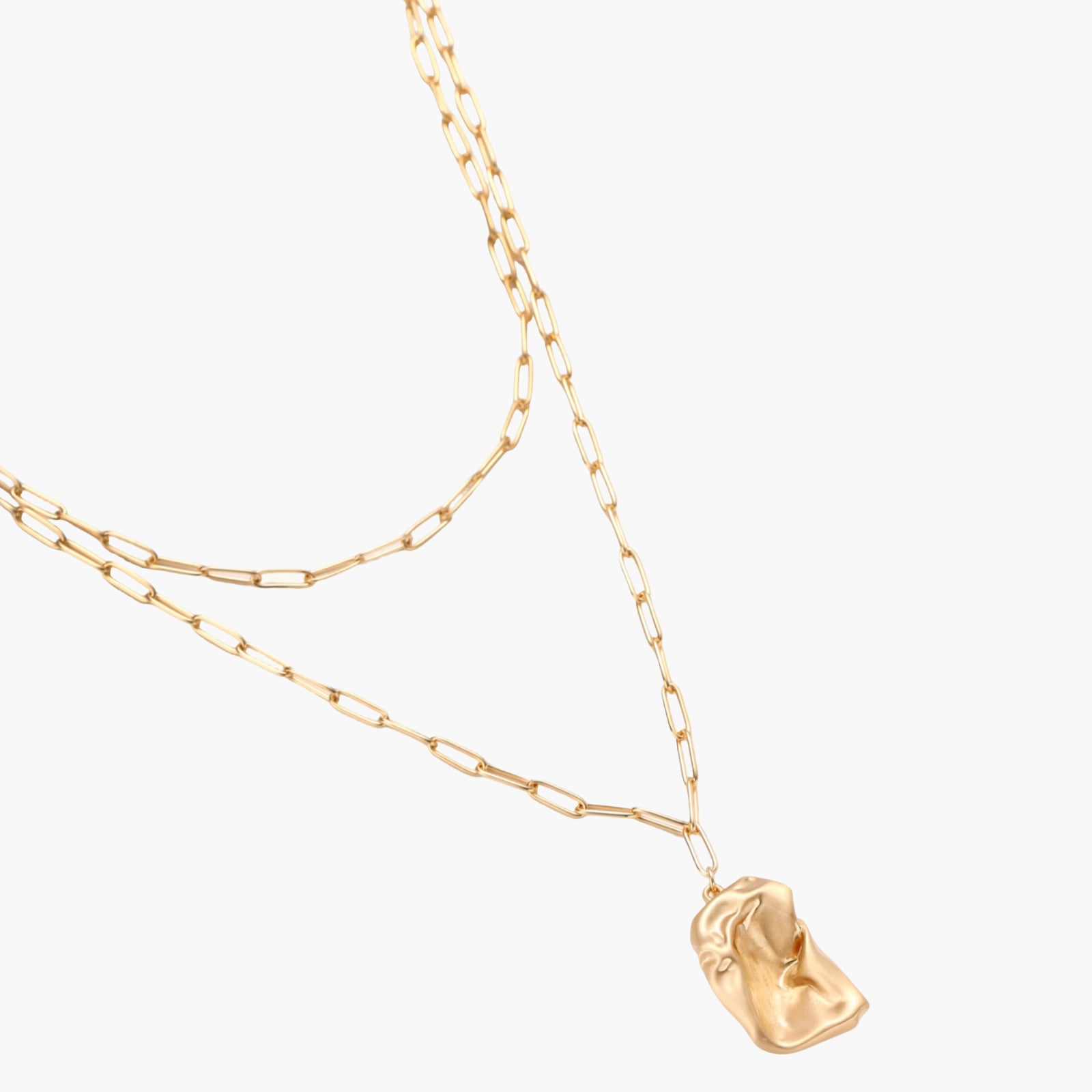 Layered paperclip chain necklace with organic flowing pendant made from eco-zinc alloy in warm gold finish