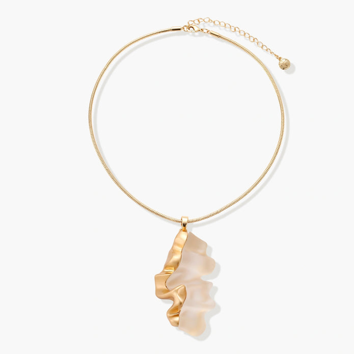 Close-up of a sculptural necklace with flowing wave pendant made from eco-zinc alloy on adjustable chain