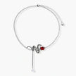 Detailed eco-brass serpent pendant necklace with red zirconia stone and crystal drop tassel on adjustable chain