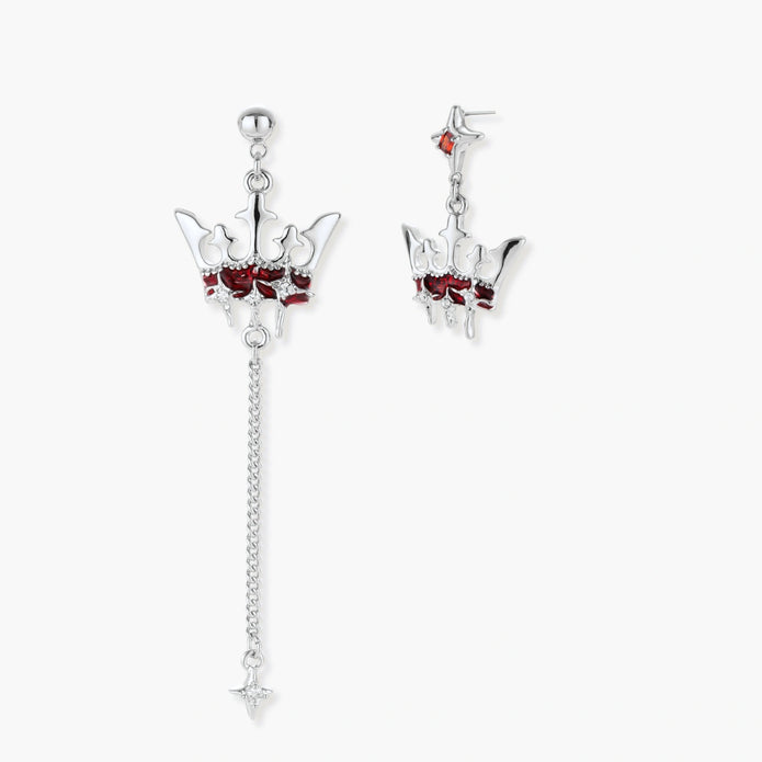 Asymmetrical crown-shaped stud earrings with red zirconia stones, one featuring a silver chain with star charm