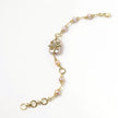 Gold-plated bracelet with pink baroque pearl centerpiece, floral connector, and freshwater pearls
