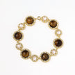 Gold-plated link bracelet with alternating brown tiger's eye stones and white freshwater pearls in ornate bezels.