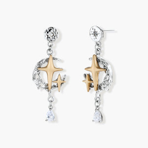 Two-tone star earrings with gold celestial motifs, silver chains, and clear crystal droplets on white background.