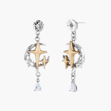 Two-tone star earrings with gold celestial motifs, silver chains, and clear crystal droplets on white background.