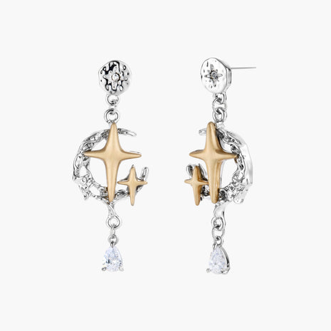 Two-tone star earrings with gold celestial motifs, silver chains, and clear crystal droplets on white background.