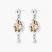 Two-tone star earrings with gold celestial motifs, silver chains, and clear crystal droplets on white background.