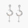 Detailed eco-brass dangle earrings featuring crescent moons with gold rope details and dangling star charms on white background.