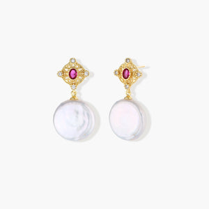 Gold baroque pearl earrings with pink gemstone studs and ornate detailing on cream background.
