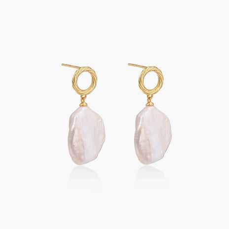 18K gold vermeil twisted circle studs with organic white baroque pearl drops on cream background