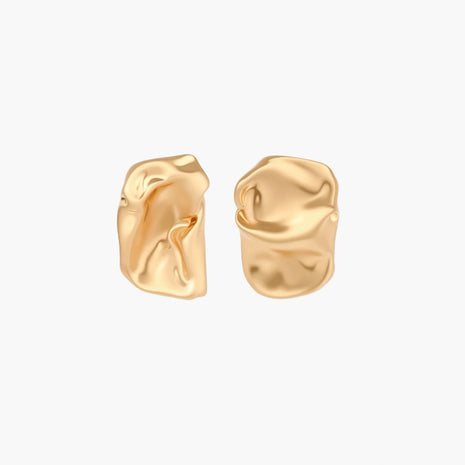 Abstract crumpled metallic earrings with fluid organic shapes in reflective gold and silver finish on neutral background.