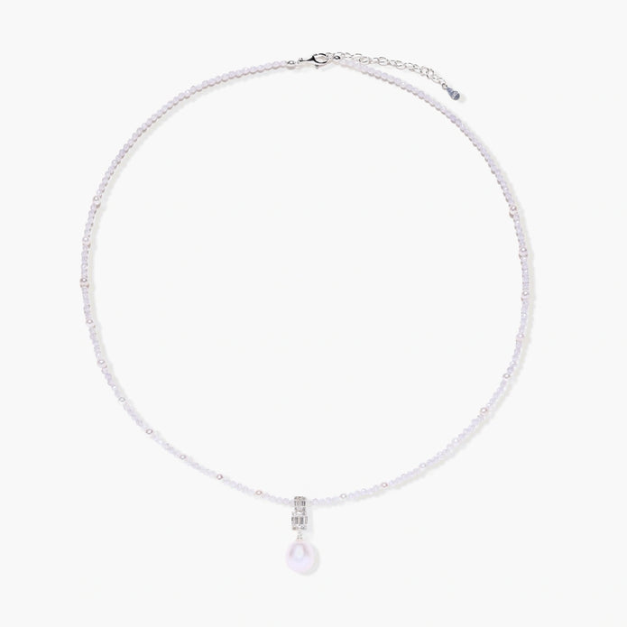 Dainty necklace with lavender crystal beads, freshwater pearls, geometric pendant, and large pearl drop on white background.