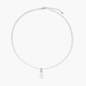 Dainty necklace with lavender crystal beads, freshwater pearls, geometric pendant, and large pearl drop on white background.