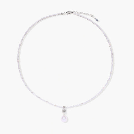 Dainty necklace with lavender crystal beads, freshwater pearls, geometric pendant, and large pearl drop on white background.