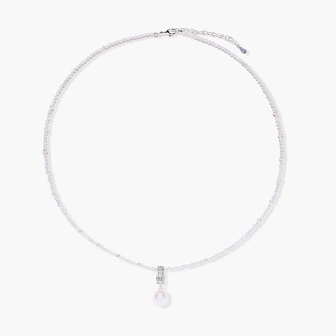 Dainty necklace with lavender crystal beads, freshwater pearls, geometric pendant, and large pearl drop on white background.