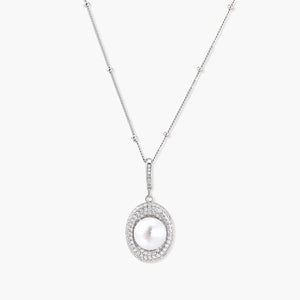 Oval sterling silver pendant with crystal halo surrounding a white freshwater pearl on delicate chain