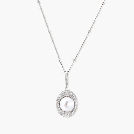 Oval sterling silver pendant with crystal halo surrounding a white freshwater pearl on delicate chain
