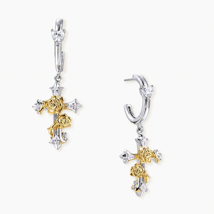 Two-tone silver and gold-plated cross drop earrings with rose motifs and zirconia stones on a huggie hoop base.