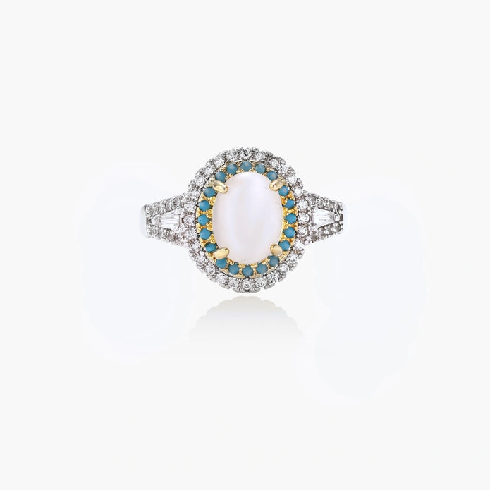 Vintage-style cocktail ring with luminous cat's eye center stone surrounded by turquoise and crystal double halo on white gold plated band