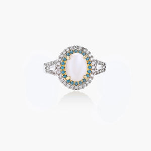 Vintage-style cocktail ring with luminous cat's eye center stone surrounded by turquoise and crystal double halo on white gold plated band