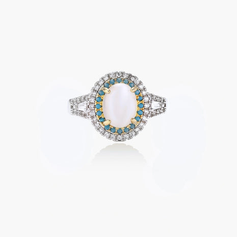Vintage-style cocktail ring with luminous cat's eye center stone surrounded by turquoise and crystal double halo on white gold plated band