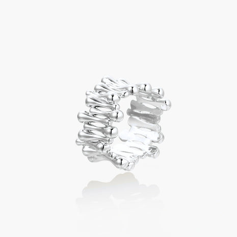 Wide band ring with sculptural wave ripples in polished white gold plated eco-brass on cream background