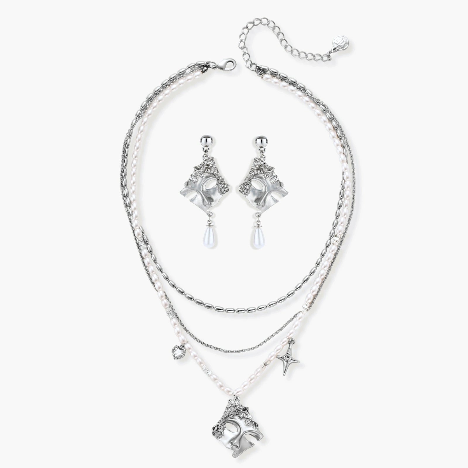 Ornate silver-toned masquerade mask jewelry set featuring rhinestone details and pearl drop earrings on white background.