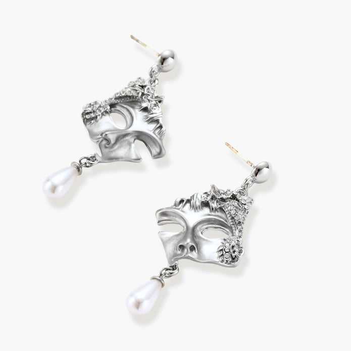 Ornate silver-toned masquerade mask jewelry set featuring rhinestone details and pearl drop earrings on white background.