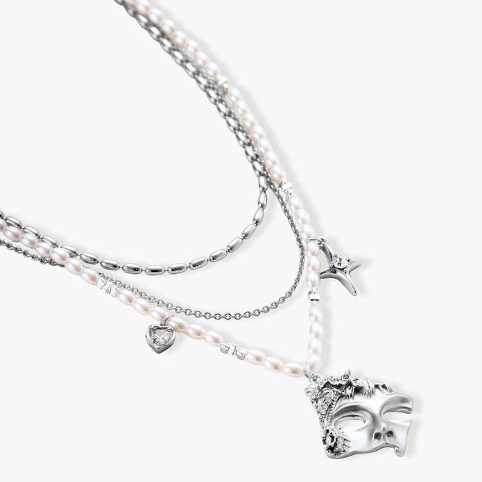 Ornate silver-toned masquerade mask jewelry set featuring rhinestone details and pearl drop earrings on white background.