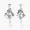 Ornate silver-toned masquerade mask jewelry set featuring rhinestone details and pearl drop earrings on white background.