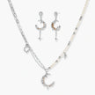 Mixed-metal jewelry set featuring layered necklaces with crescent moon pendant and pearl beads, plus matching star-drop earrings.