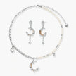 Mixed-metal jewelry set featuring layered necklaces with crescent moon pendant and pearl beads, plus matching star-drop earrings.
