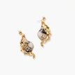 Close-up of metallic dragon-wrapped earrings with marbled resin stones on white background