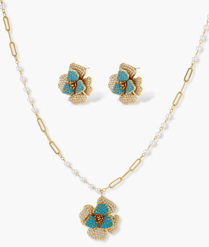 14K gold-plated floral jewelry set with blue cubic zirconia centers and pearl chain details on white background.