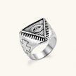 Silver stainless steel signet ring with engraved all-seeing eye in triangle, radiating lines, and cross motifs on the band.