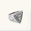 Silver stainless steel signet ring with engraved all-seeing eye in triangle, radiating lines, and cross motifs on the band.