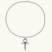 Silver stainless steel ankh pendant with skull motifs on vertical bar and textured ring top, on a box chain necklace.