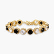Gold-plated jewelry set with alternating black and clear cubic zirconia stones, featuring necklace, earrings and bracelet