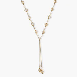 Adjustable gold lariat necklace with freshwater pearls nested in delicate cage settings and Y-shaped tassel drop