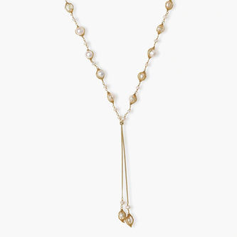 Adjustable gold lariat necklace with freshwater pearls nested in delicate cage settings and Y-shaped tassel drop