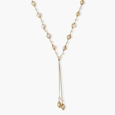 Adjustable gold lariat necklace with freshwater pearls nested in delicate cage settings and Y-shaped tassel drop