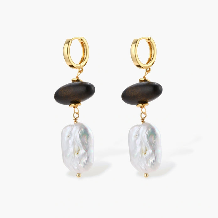 Gold hoop earrings with dark wood beads and baroque freshwater pearls, shown from multiple angles on cream background.