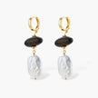 Gold hoop earrings with dark wood beads and baroque freshwater pearls, shown from multiple angles on cream background.